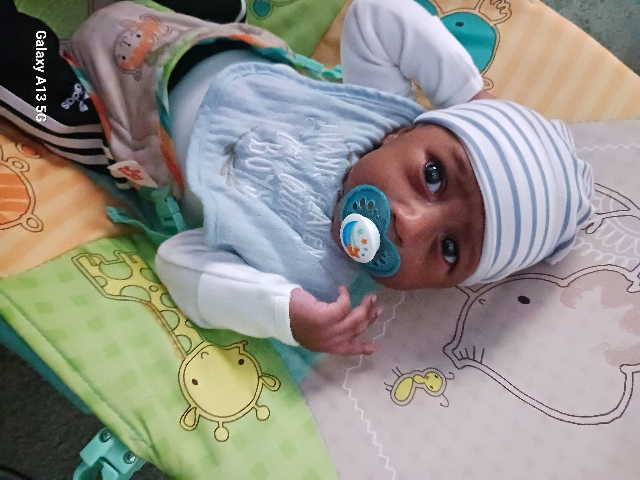 Knowledge is registered to the contest to win money with this photo: adaptation, art, baby, child, circle, green, headwear, linens, organism, pattern, person, room, textile, toddler, visual_arts