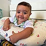 Joao Miguel a rejoint le concours — aidez-le/la à gagner de superbes lots ! baby, infant, smiling, face, pillow, patterned_pillow, bedroom, headboard, white, cute, child, person, arm, hand, clothing, toddler, happy, indoors, lying, closeup