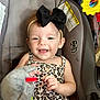 baby, child, smiling, headband, black_bow, leopard_print, top, denim_shorts, car_seat, toy, soft_toy, hand, happy, infant, cute, indoors, seatbelt, closeup, portrait, playful