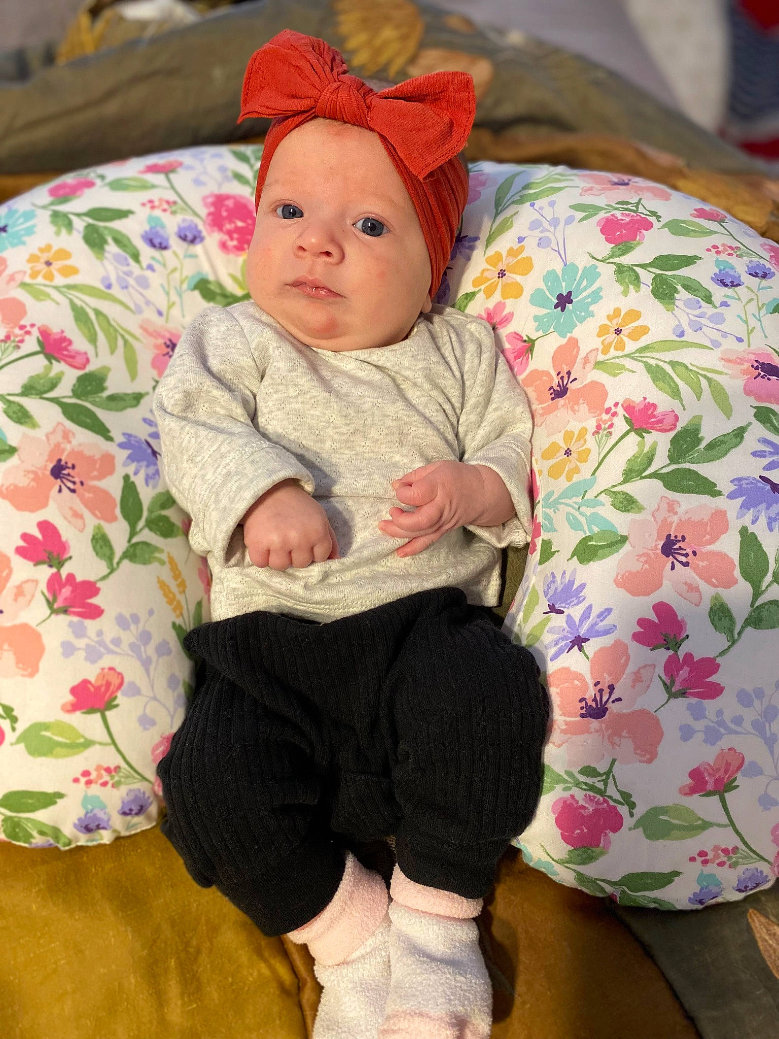 Charley is registered to the contest to win money with this photo: baby, baby_toddler_clothing, cap, cheek, child, comfort, eye, face, headgear, knee, linens, pattern, person, pink, sitting, skin, sleeve, sock, textile, toddler