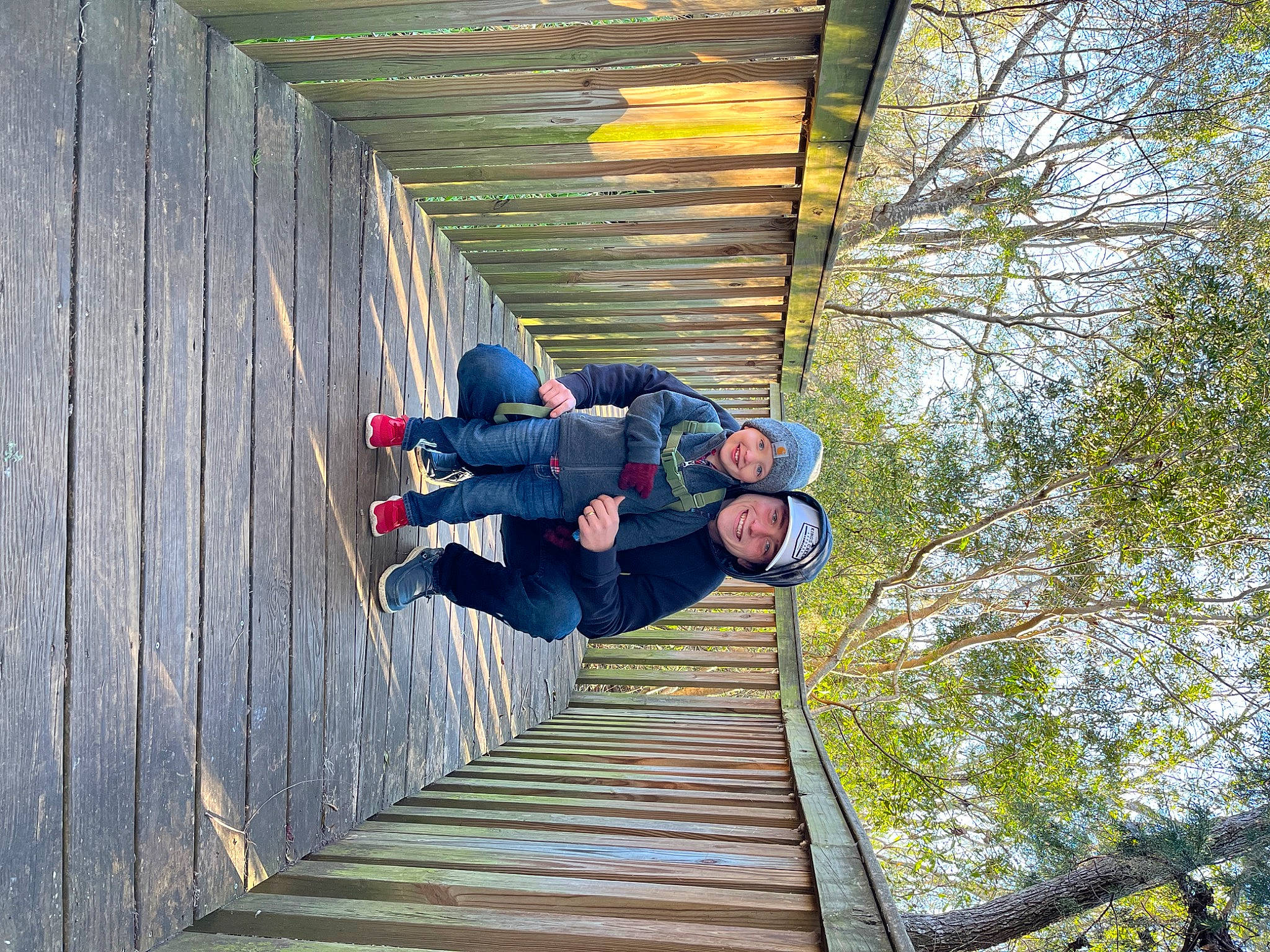 Kasen is registered to the contest to win money with this photo: adventure, backpack, fun, glasses, grass, headwear, jacket, joy, leisure, luggage_and_bags, outdoor_shoe, people_in_nature, person, plant, recreation, sky, stairs, symmetry, travel, tree