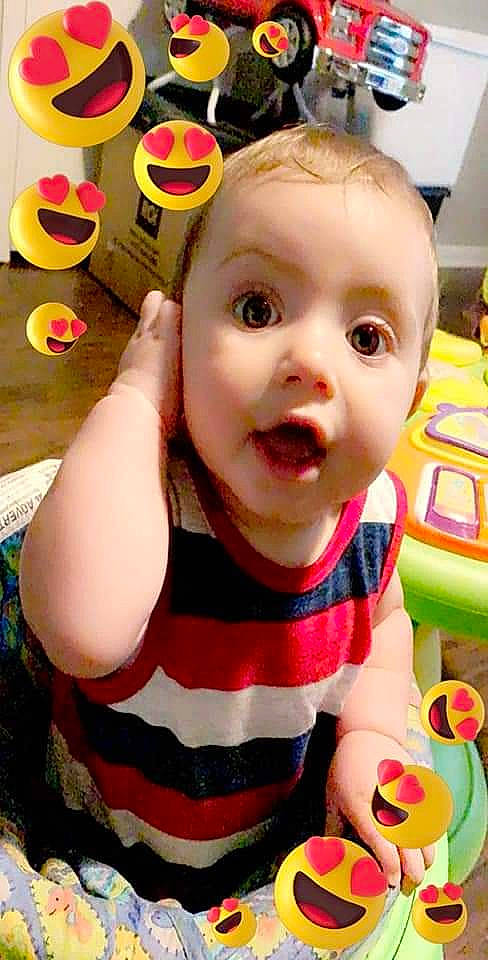 Cassius is registered to the contest to win money with this photo: baby, baby_products, baby_toys, brown_hair, cheek, child, face, facial_expression, head, lip, mouth, nose, person, play, product, skin, smile, surprise, toddler, toy