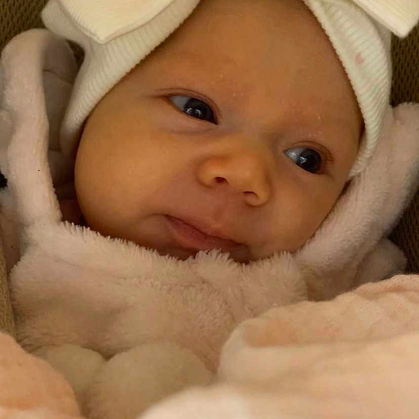 Amelia joined the competition — help win amazing prizes! baby, blanket, bow, child, closeup, clothing, cozy, cute, face, headwear, indoors, infant, newborn, pink, portrait, resting, sleepy, soft_texture, warm, white