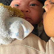 Jaxani joined the competition — help win amazing prizes! baby, child, infant, hat, blanket, close_up, face, person, adult, affection, cozy, warm, nose, eyelashes, skin, clothing, texture, intimate, portrait, indoor