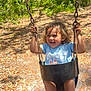 toddler, child, swing, outdoor, forest, trees, sunlight, smiling, happy, playground, rusty_chain, black_swing, curly_hair, blue_shirt, black_shoes, nike, nature, daylight, leaves, joy