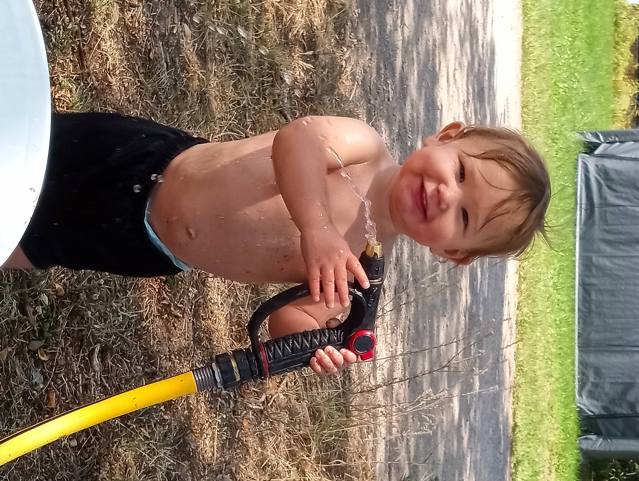 Tega is registered to the contest to win money with this photo: agriculture, bag, baggage, barechested, blond, child, fun, grass, happy, human_body, human_leg, joy, leisure, luggage_and_bags, people_in_nature, person, recreation, smile, soil, thigh