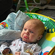 Jaye joined the competition — help win amazing prizes! baby, infant, pouty_face, pacifier, blanket, baby_rocker, colorful, clothing, indoor, toy, expression, cute, child, person, seat, fabric, comfort, young, head, hands