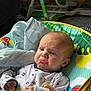 baby, infant, pouty_face, pacifier, blanket, baby_rocker, colorful, clothing, indoor, toy, expression, cute, child, person, seat, fabric, comfort, young, head, hands