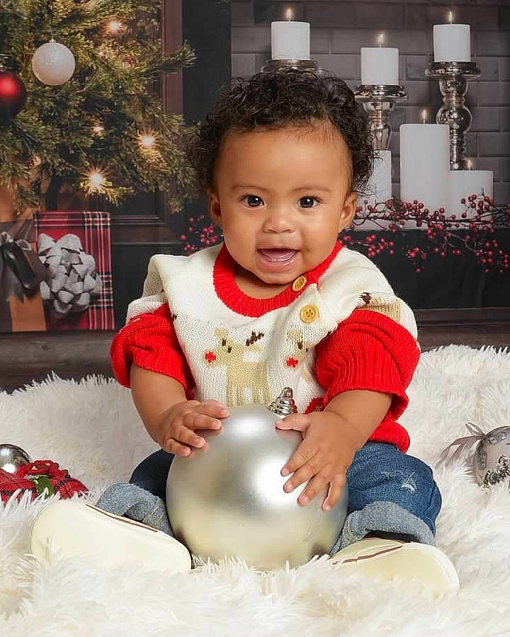 Jem is registered to the contest to win money with this photo: baby, baby_toddler_clothing, christmas, christmas_decoration, christmas_eve, christmas_lights, christmas_ornament, christmas_tree, conifer, holiday, holiday_ornament, interior_design, living_room, ornament, person, porcelain, toddler, toy