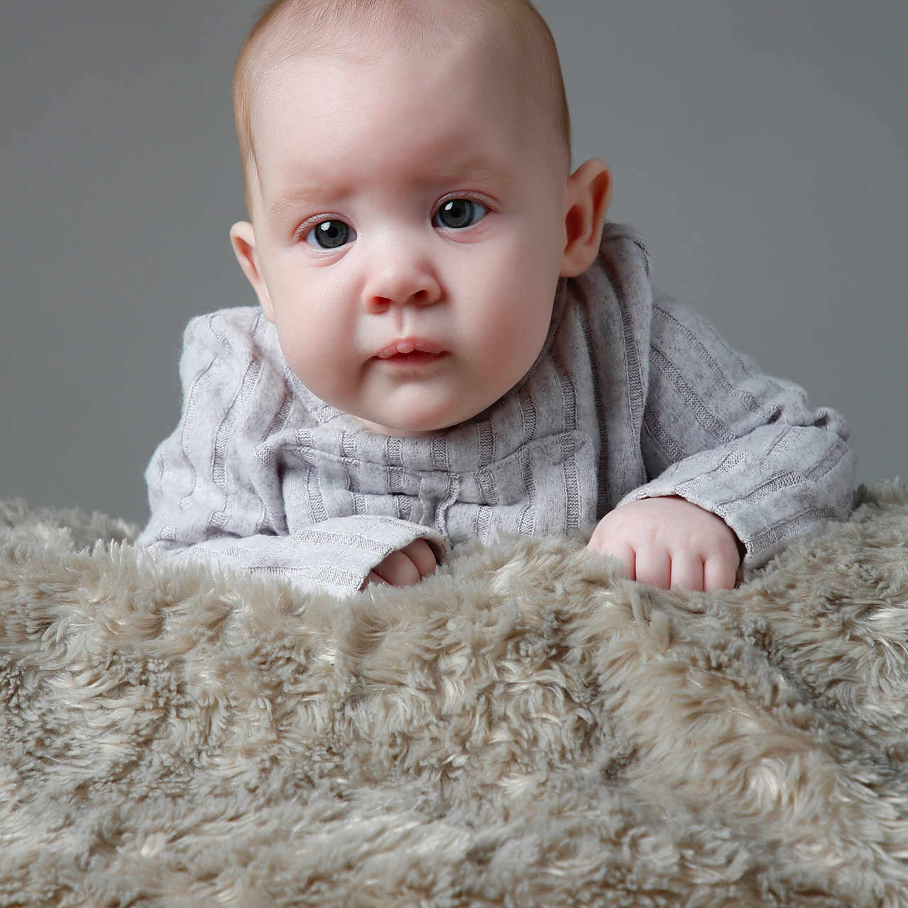 Roseabella joined the competition — help win amazing prizes! baby, blanket, blue_eyes, child, closeup, cute, expression, face, fur_texture, hands, indoor, infant, knitted_clothing, looking, neutral_background, portrait, skin, soft, sweater, young