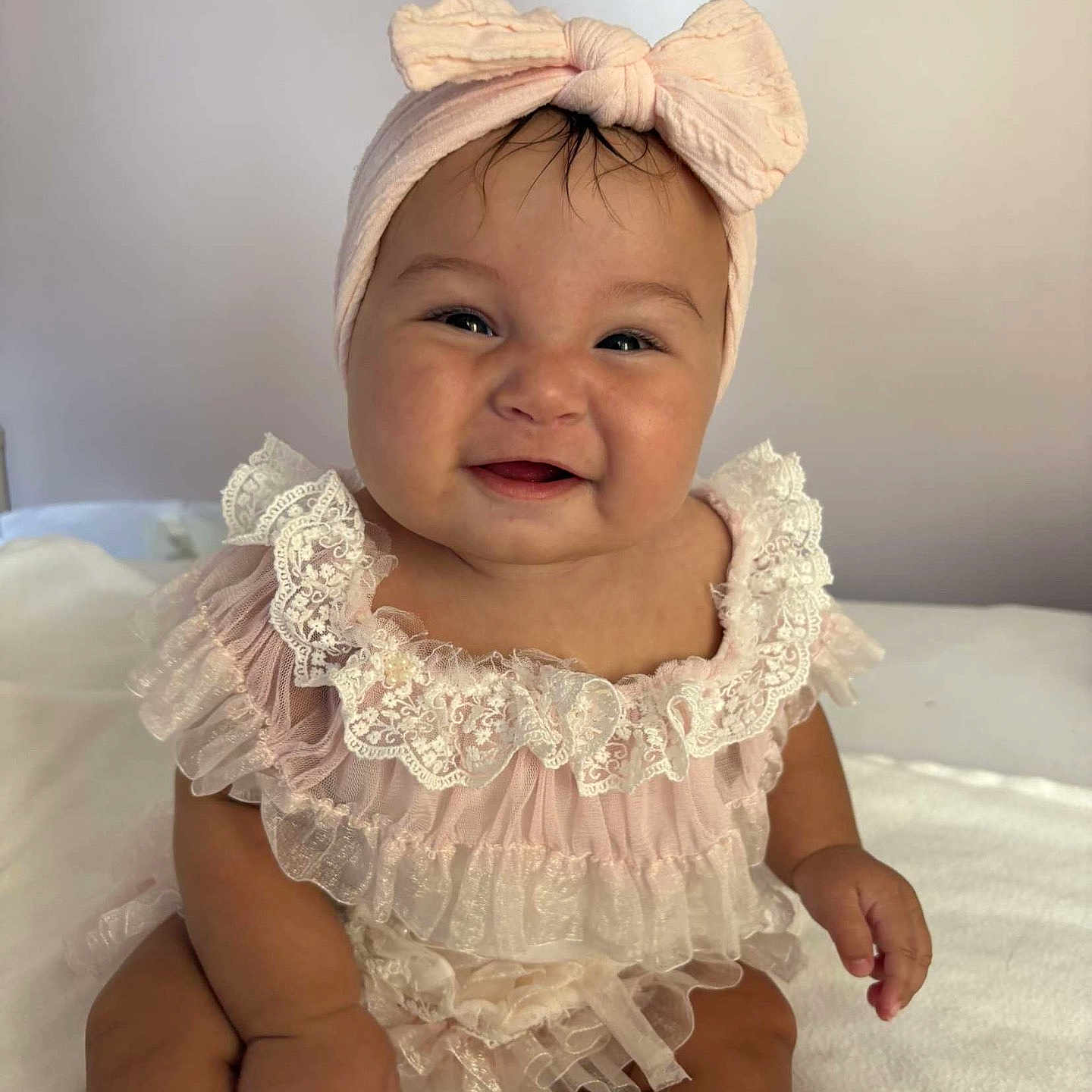 Ruby participe au concours pour gagner de l'argent avec cette photo : adorable, baby, bow, child, chubby, cute, dress, frills, happy, headband, indoors, infant, lace, person, pink, portrait, sitting, smile, soft, white_background