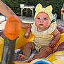 Ruby a rejoint le concours — aidez-le/la à gagner de superbes lots ! baby, infant, yellow_headband, yellow_swimsuit, inflatable_toy, pool, water, outdoor, summer, child, cute, headwear, hand, greenery, blurred_background, sitting, playtime, sunny, skin, expression