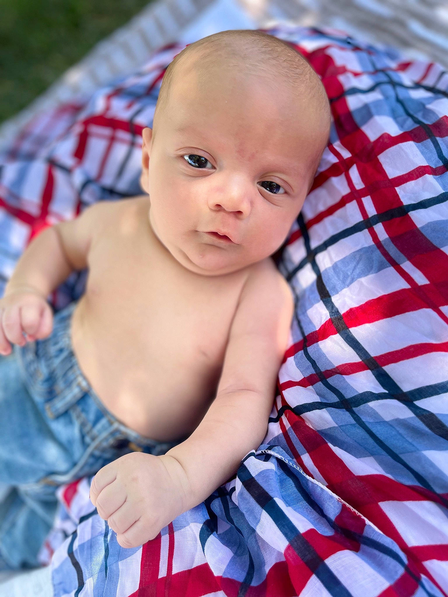 Kolton joined the competition — help win amazing prizes! azure, baby, baby_toddler_clothing, cheek, child, electric_blue, eye, face, fun, grass, happy, iris, mammal, pattern, person, sitting, skin, tartan, textile, toddler