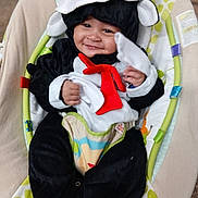 Damien Jr joined the competition — help win amazing prizes! baby, child, smiling, costume, animal_costume, red_tie, hat, baby_seat, colorful, cute, happy, infant, indoors, portrait, plush, soft_toys, comfortable, face, person, closeup