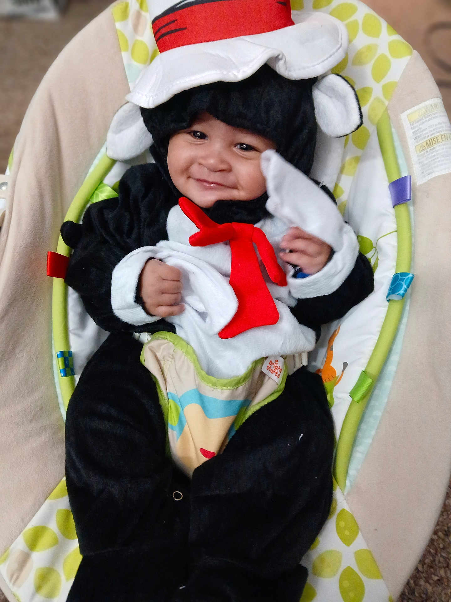 Damien Jr joined the competition — help win amazing prizes! baby, child, smiling, costume, animal_costume, red_tie, hat, baby_seat, colorful, cute, happy, infant, indoors, portrait, plush, soft_toys, comfortable, face, person, closeup
