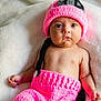 Mila joined the competition — help win amazing prizes! baby, infant, newborn, pink_hat, knit_hat, pink_clothing, blanket, cozy, cute, portrait, big_eyes, staring, cheeks, bare_chest, hand, button, lying_down, soft_texture, indoors, plush