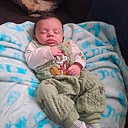 Ra'Mellio joined the competition — help win amazing prizes! baby, blanket, cartoon_character, child, clothing, comfort, couch, cozy, cute, face, green_outfit, indoors, infant, person, portrait, resting, sleeping, socks, soft, young