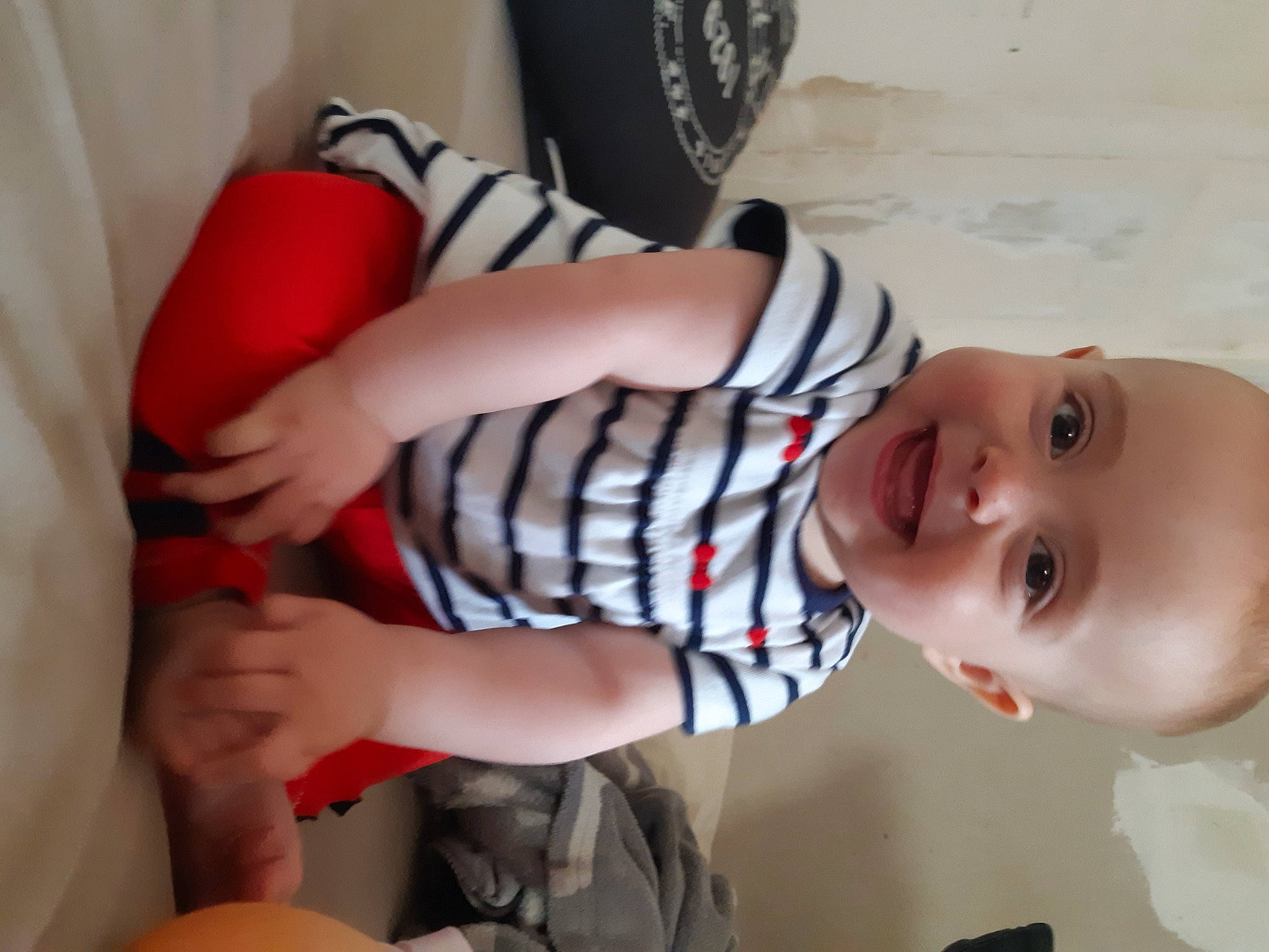 Ruby participe au concours pour gagner de l'argent avec cette photo : arm, baby_toddler_clothing, cheek, comfort, eye, finger, gesture, hand, human_body, joint, joy, leg, mouth, nose, orange, person, skin, sleeve, smile, textile