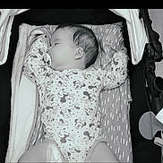 Elyana a rejoint le concours — aidez-le/la à gagner de superbes lots ! baby, sleeping, pacifier, mickey_mouse, onesie, stroller, cushion, infant, child, resting, cute, clothing, pattern, comfort, relaxation, indoors, monochrome, portrait, peaceful, young