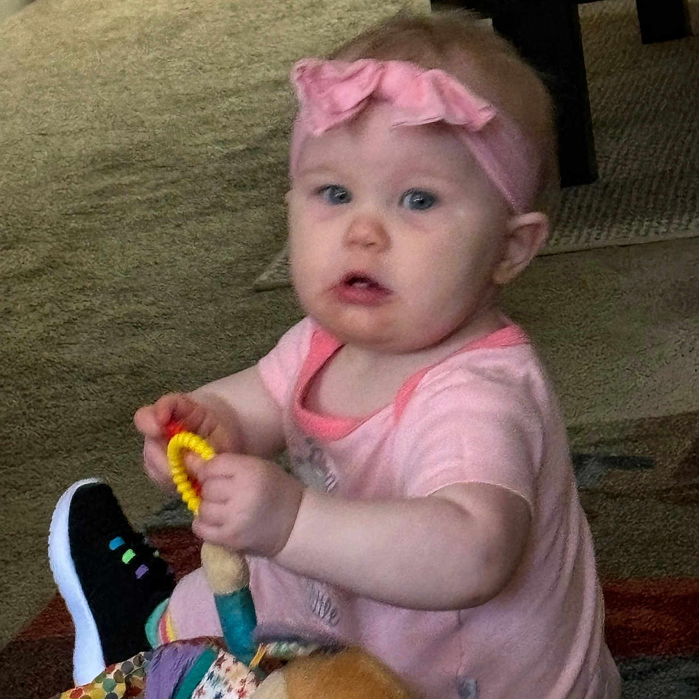 Ellie is registered to the contest to win money with this photo: baby, bodypart, brush, clothing, couch, cutlery, device, face, finger, footwear, furniture, hand, head, person, photography, portrait, shoe, spoon, tool, toy