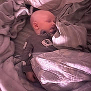 Blake is registered to the contest to win money with this photo: baby, sleeping, blanket, pajamas, bed, sleep, cozy, child, face, infant, comfort, soft, peaceful, cute, indoors, toddler, rest, covered, portrait, calm