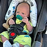 Blake is registered to the contest to win money with this photo: baby, infant, car_seat, pacifier, green_outfit, dinosaur_print, soft_toy, headrest, straps, socks, cute, child, car_interior, seatbelt, newborn, sitting, small_hands, portrait, closeup, comfort