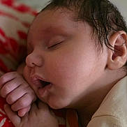 Leo is registered to the contest to win money with this photo: newborn, baby, sleeping, yawning, portrait, face, eyes_closed, infant, child, hand, fist, hair, indoors, bed, blanket, bedding, cozy, close_up, resting, photography