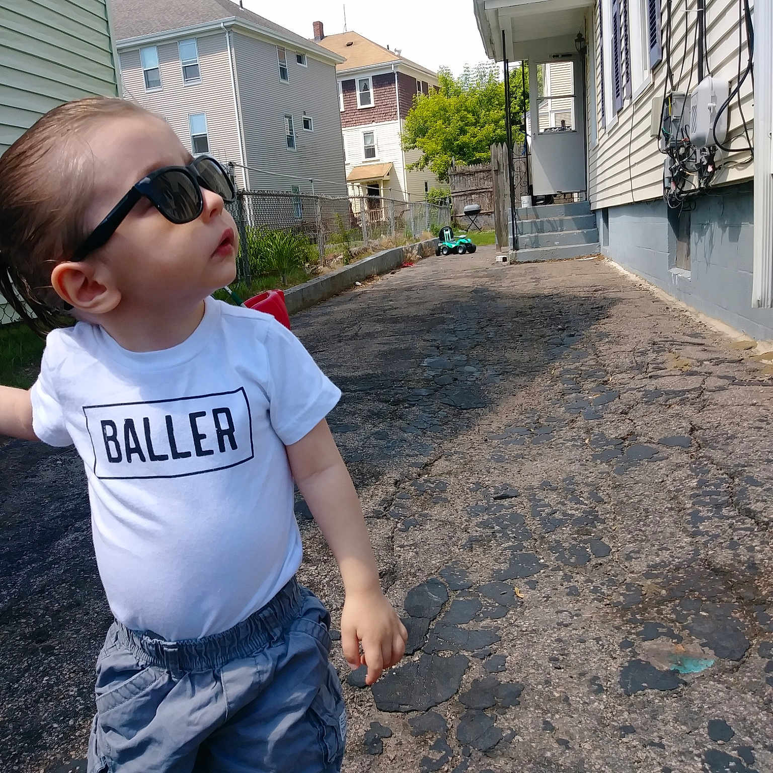 Michael is registered to the contest to win money with this photo: asphalt, child, fun, home, jeans, residential_area, street, t_shirt, toddler, vacation