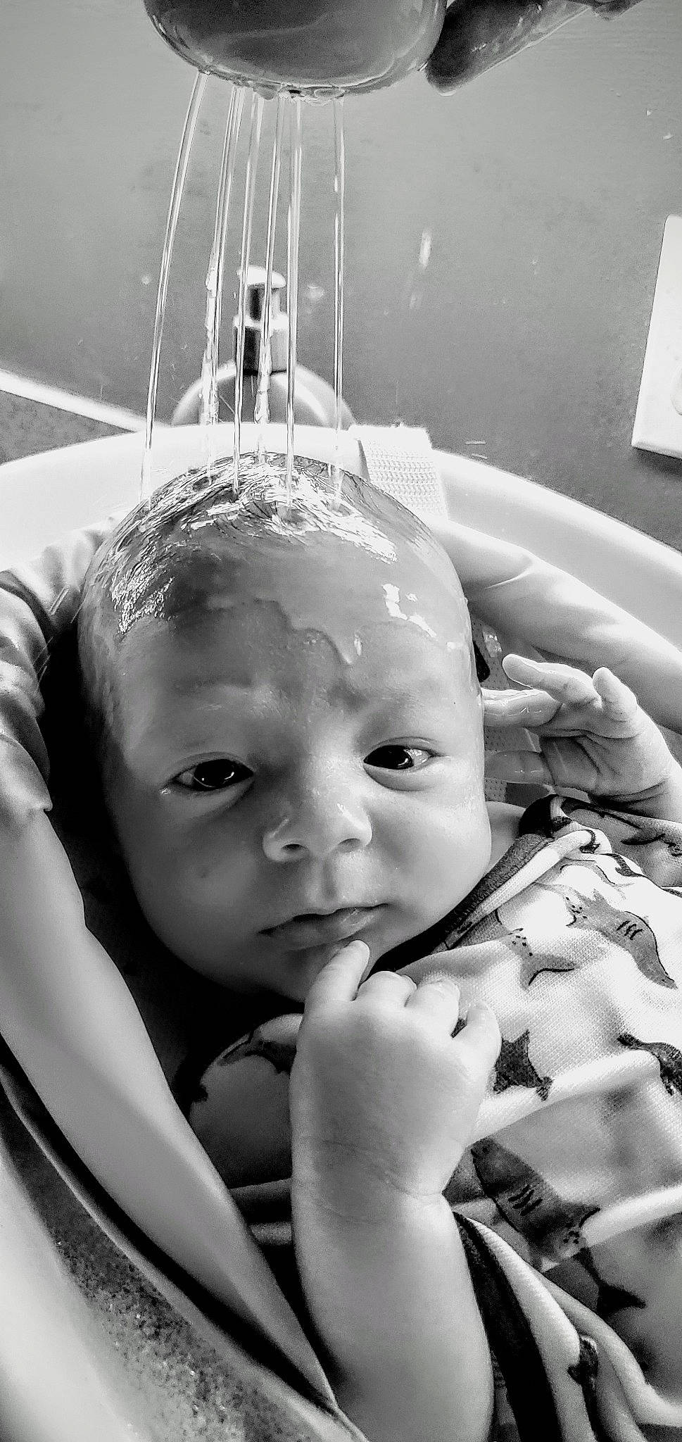 River is registered to the contest to win money with this photo: arm, baby, black, black_and_white, cheek, eye, eyebrow, eyelash, facial_expression, gesture, hand, happy, iris, lip, mouth, nose, organ, person, photograph, skin