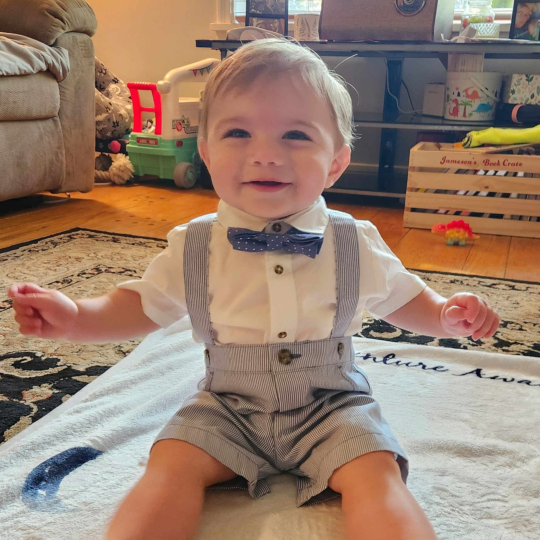 Jameson joined the competition — help win amazing prizes! accessories, architecture, baby, building, clothing, couch, face, formalwear, furniture, head, indoors, livingroom, pants, person, photography, portrait, room, shorts, sitting, tie