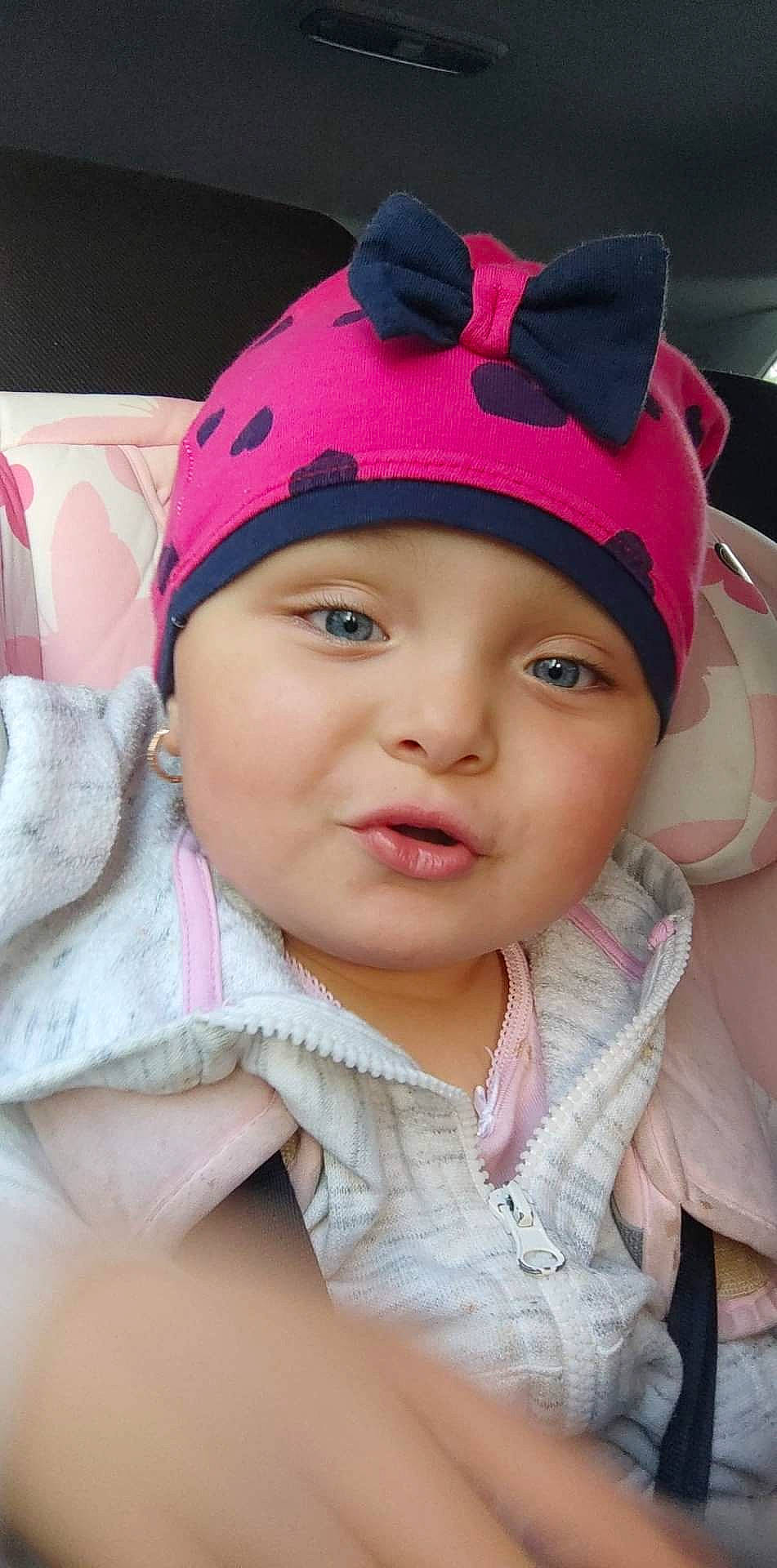 Annalise joined the competition — help win amazing prizes! cap, cheek, chin, ear, eye, eyebrow, eyelash, face, happy, head, headgear, headwear, human_body, lip, neck, nose, outerwear, person, pink, skin