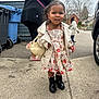 child, toddler, girl, sidewalk, coat, dress, boots, purse, smiling, outdoor, street, adult, trash_bins, house, cloudy_sky, person, curly_hair, casual, urban, daytime