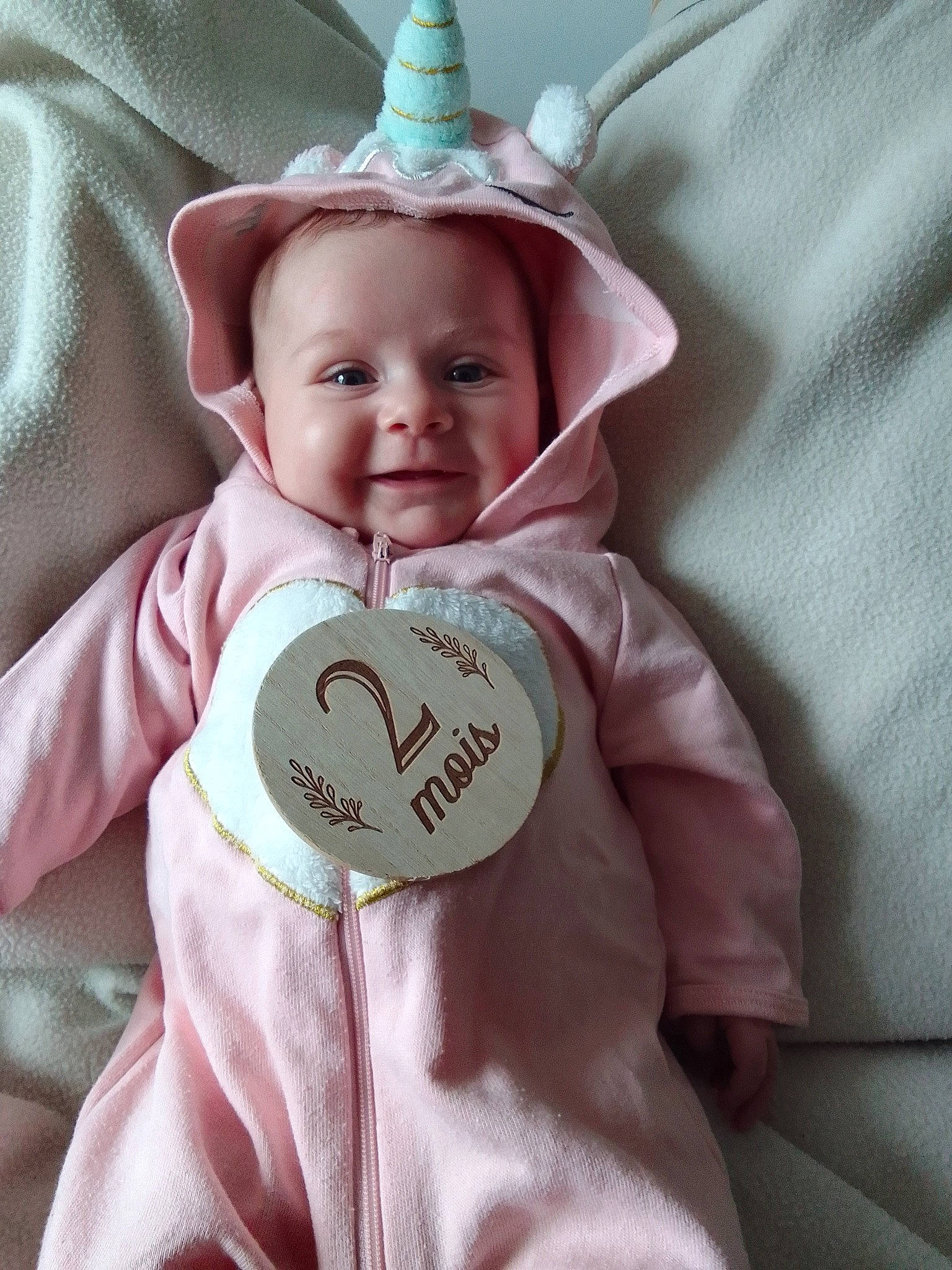 Mya a rejoint le concours — aidez-le/la à gagner de superbes lots ! baby, baby_toddler_clothing, cap, cheek, child, comfort, costume_hat, eye, face, happy, head, linens, outerwear, party_hat, person, pink, sleeve, smile, textile, toddler