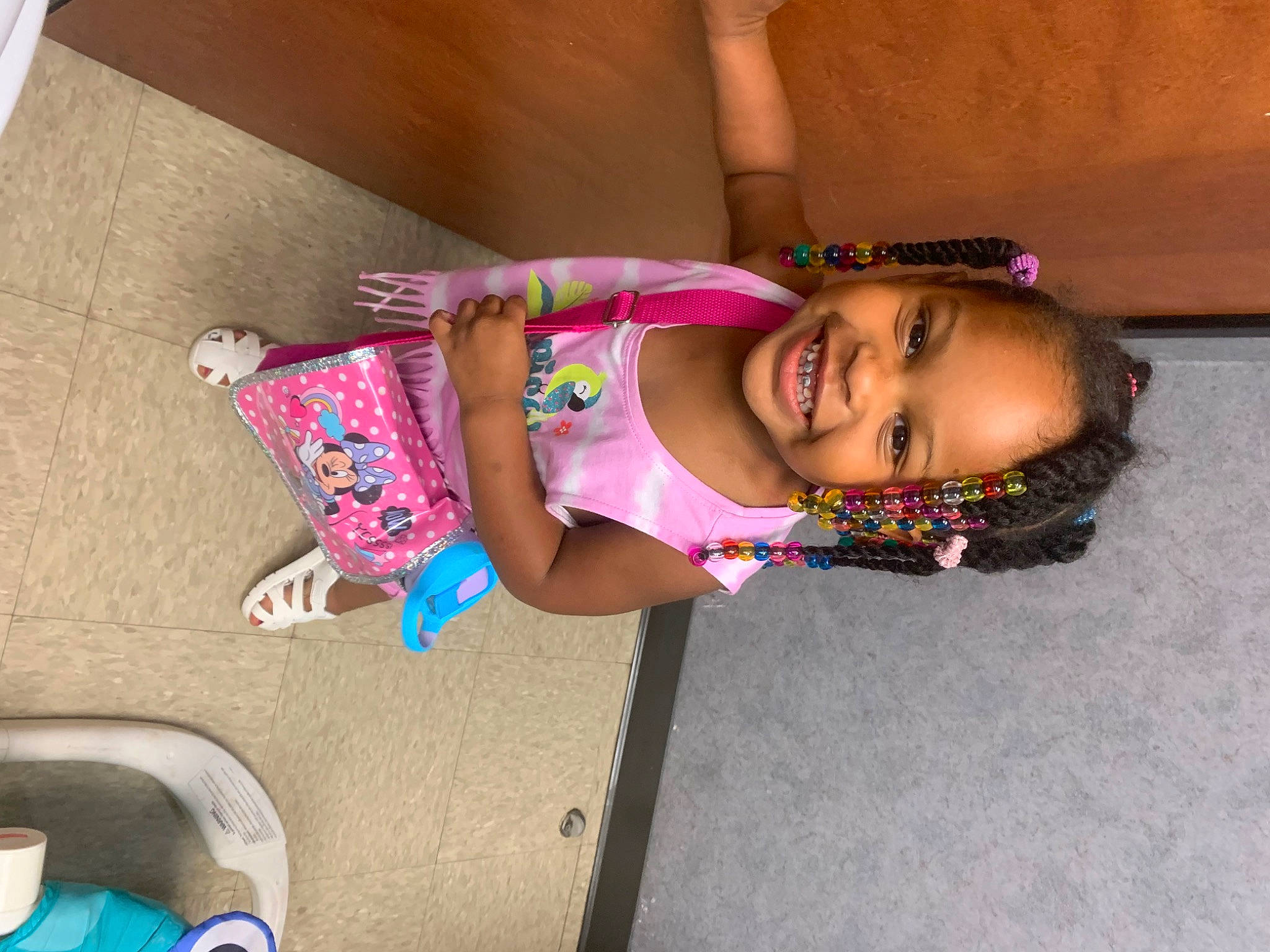 Queen is registered to the contest to win money with this photo: baby_toddler_clothing, child, dress, flooring, fun, happy, human_leg, joint, joy, knee, leisure, magenta, mammal, pattern, person, pink, sandal, skin, smile, thigh