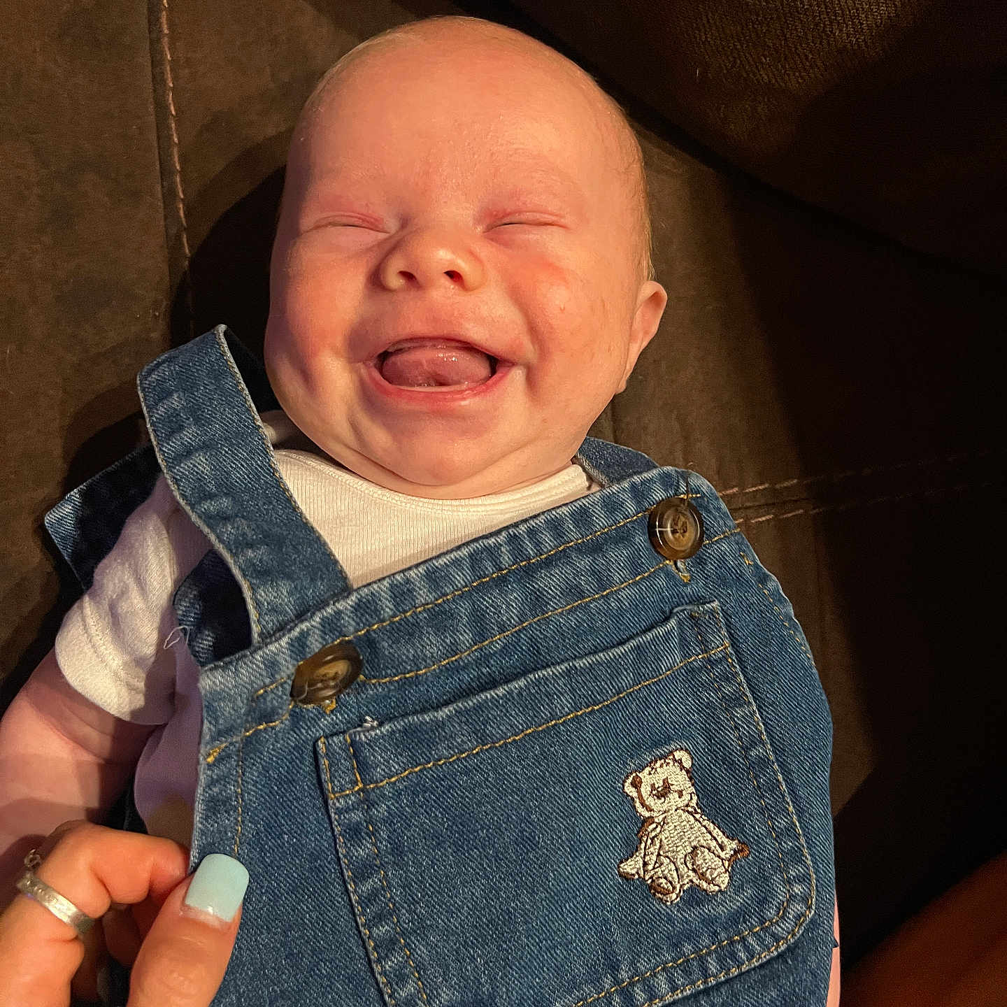 Hanson joined the competition — help win amazing prizes! baby, babylaughing, bodypart, clothing, coat, couch, face, finger, furniture, hand, happy, head, jacket, jeans, newborn, pants, person, photography, portrait, smile