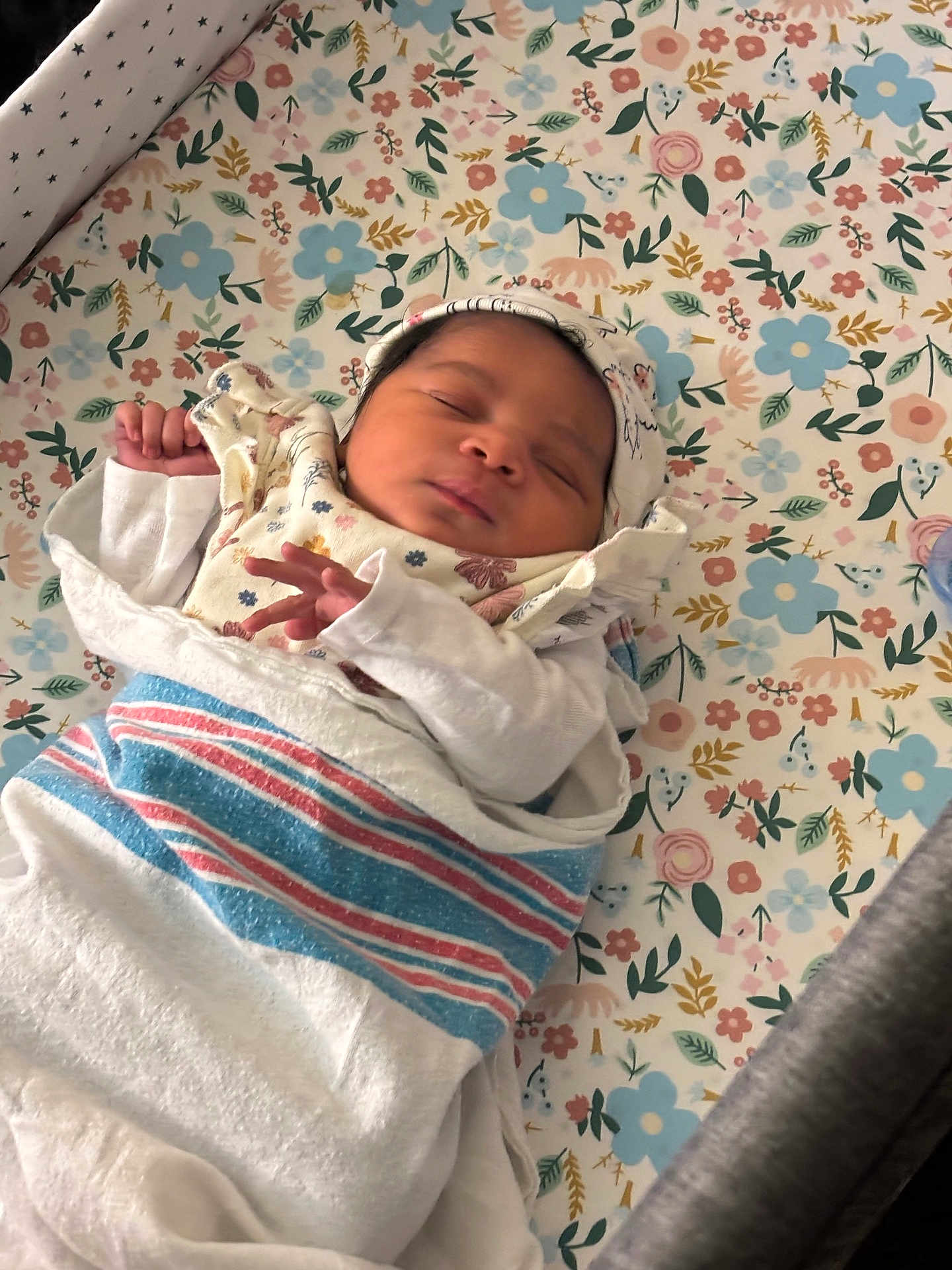 Solana is registered to the contest to win money with this photo: baby, newborn, sleeping, blanket, hat, floral_pattern, bed, crib, peaceful, infant, wrapped, child, soft, cute, indoors, resting, portrait, person, small, cozy