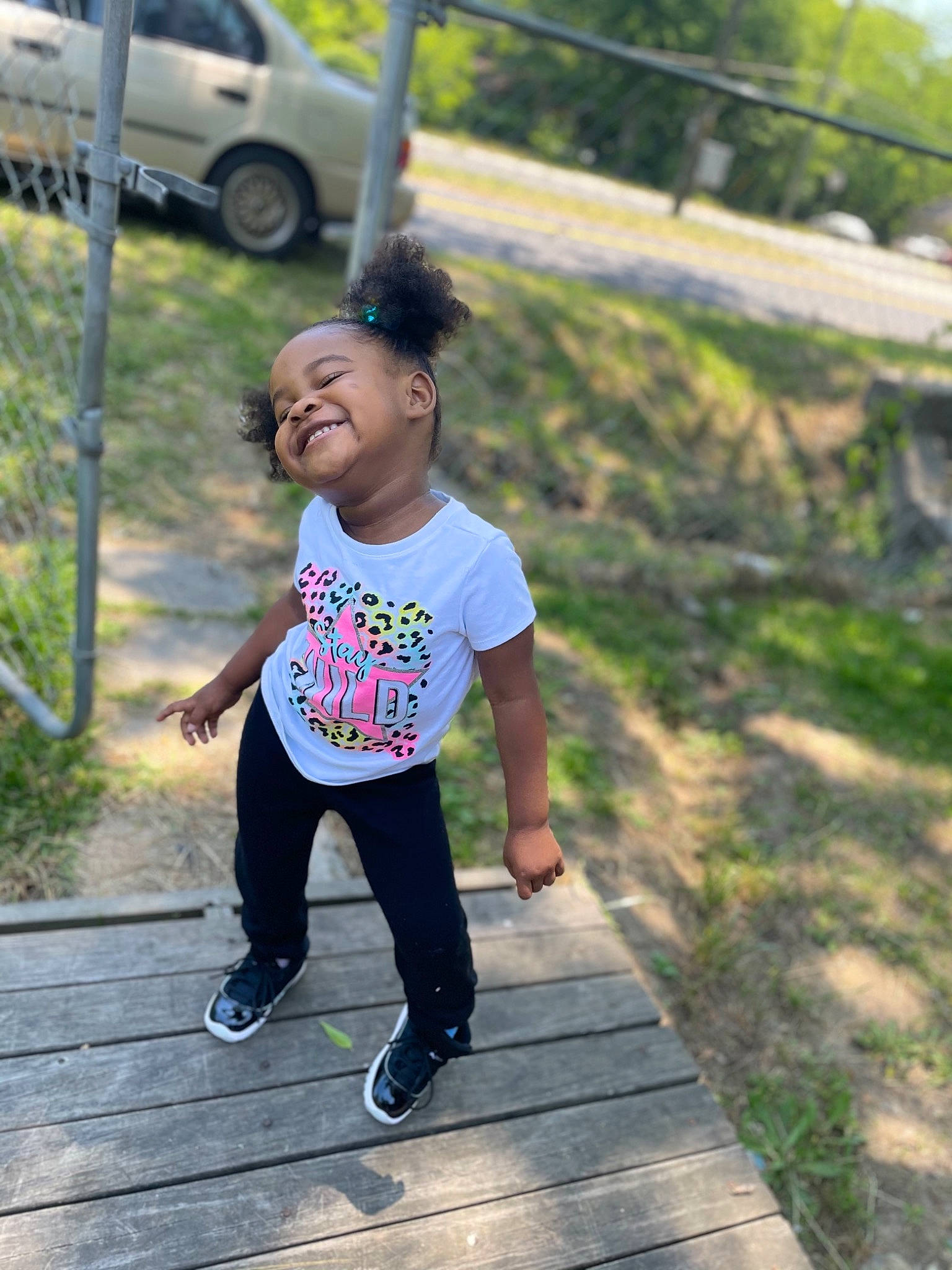 Harmonii is registered to the contest to win money with this photo: asphalt, automotive_exterior, automotive_tire, car, child, family_car, fun, grass, happy, joy, leisure, person, plant, recreation, road, smile, sweatpant, t_shirt, tire, toddler