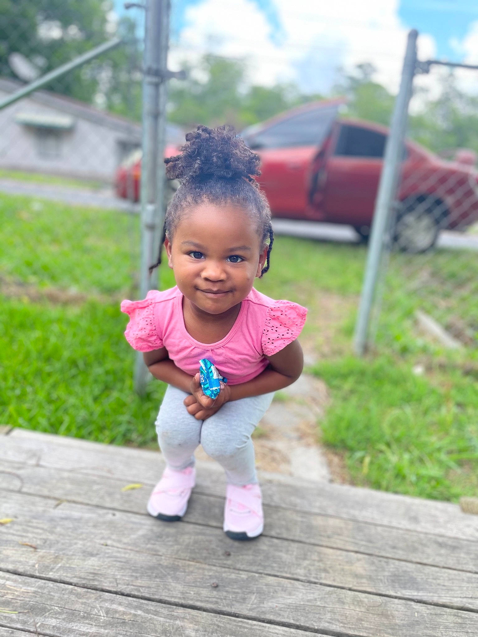 Harmonii is registered to the contest to win money with this photo: baby, baby_toddler_clothing, car, child, eye, fun, grass, hair, happy, head, joy, leisure, magenta, people_in_nature, person, pink, plant, public_space, sky, smile