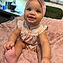 Jazleigh is registered to the contest to win money with this photo: baby, infant, child, smiling, happy, headband, bow, floral_outfit, blanket, pink, feet, hands, indoor, lamp, furniture, couch, portrait, cute, toddler, person
