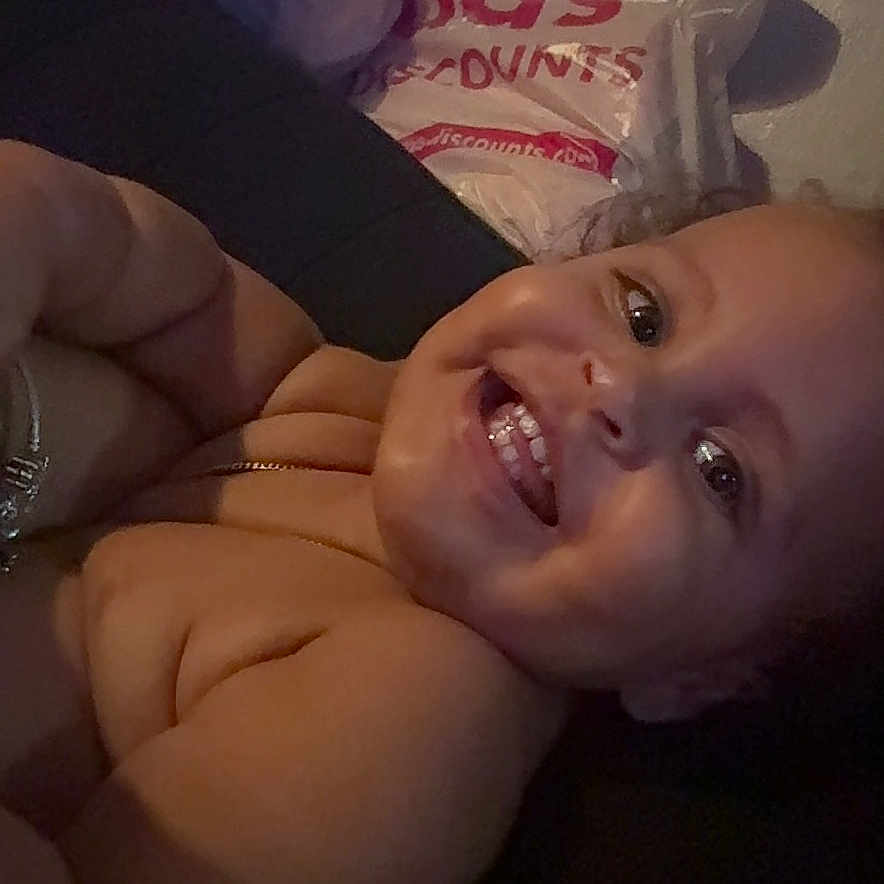 Ahaziah joined the competition — help win amazing prizes! arm, baby, bracelet, child, closeup, cute, expression, face, happy, head, indoor, light, person, plastic_bags, shadow, shopping_bags, skin, smile, teeth, toddler