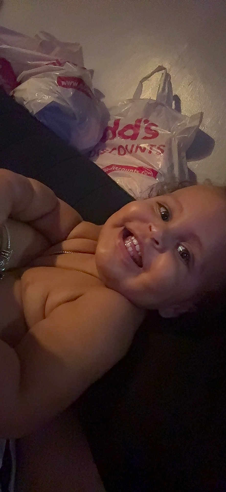 Ahaziah joined the competition — help win amazing prizes! toddler, baby, smile, face, teeth, bracelet, arm, skin, plastic_bags, shopping_bags, indoor, person, happy, cute, child, closeup, head, expression, light, shadow