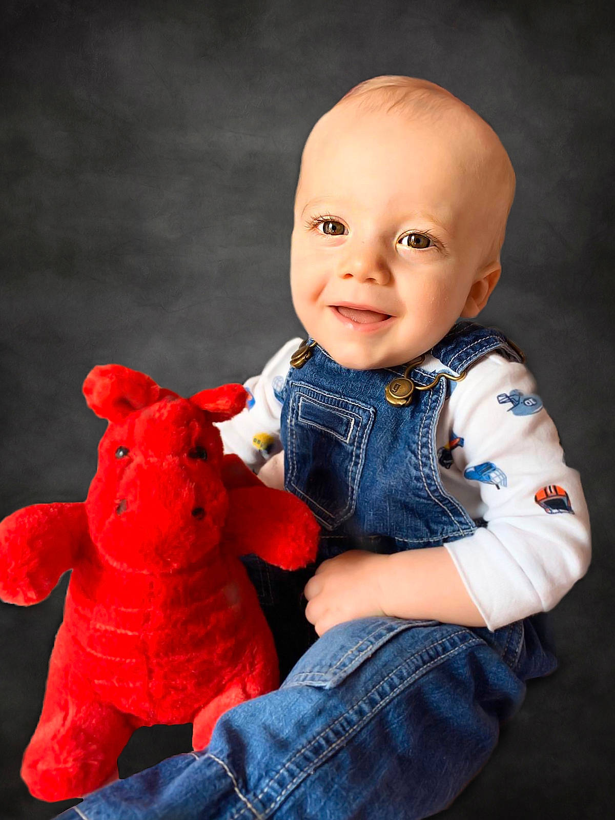 Noah is registered to the contest to win money with this photo: baby, baby_toddler_clothing, cheek, clothing, finger, flash_photography, gesture, hand, happy, jeans, joy, nose, organ, outerwear, person, red, skin, sleeve, smile, textile