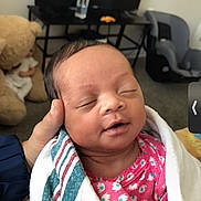 Bakari joined the competition — help win amazing prizes! baby, blanket, car_seat, child, cozy, cute, hand, home, indoor, infant, newborn, patterned_clothing, peaceful, person, pink_clothing, portrait, resting, sleeping, teddy_bear, towel