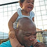 Blessin joined the competition — help win amazing prizes! blue_shirt, casual, child, curly_hair, daylight, family, fence, fun, happy, holding, joy, laughing, man, outdoor, people, portrait, shoulders, smiling, toddler, white_shoes