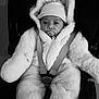baby, infant, pacifier, car_seat, stroller, winter_coat, hood, hat, seatbelt, buckle, fluffy_suit, cozy, newborn, portrait, black_and_white, cheeks, wide_eyes, hands_hidden, soft_texture, zipped_jumpsuit