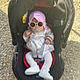 baby, infant, car_seat, stroller, sunglasses, pacifier, bonnet, white_shoes, socks, outdoor, gravel, sunlight, harness, jacket, cute, seat, headwear, accessory, cherry_print, portrait