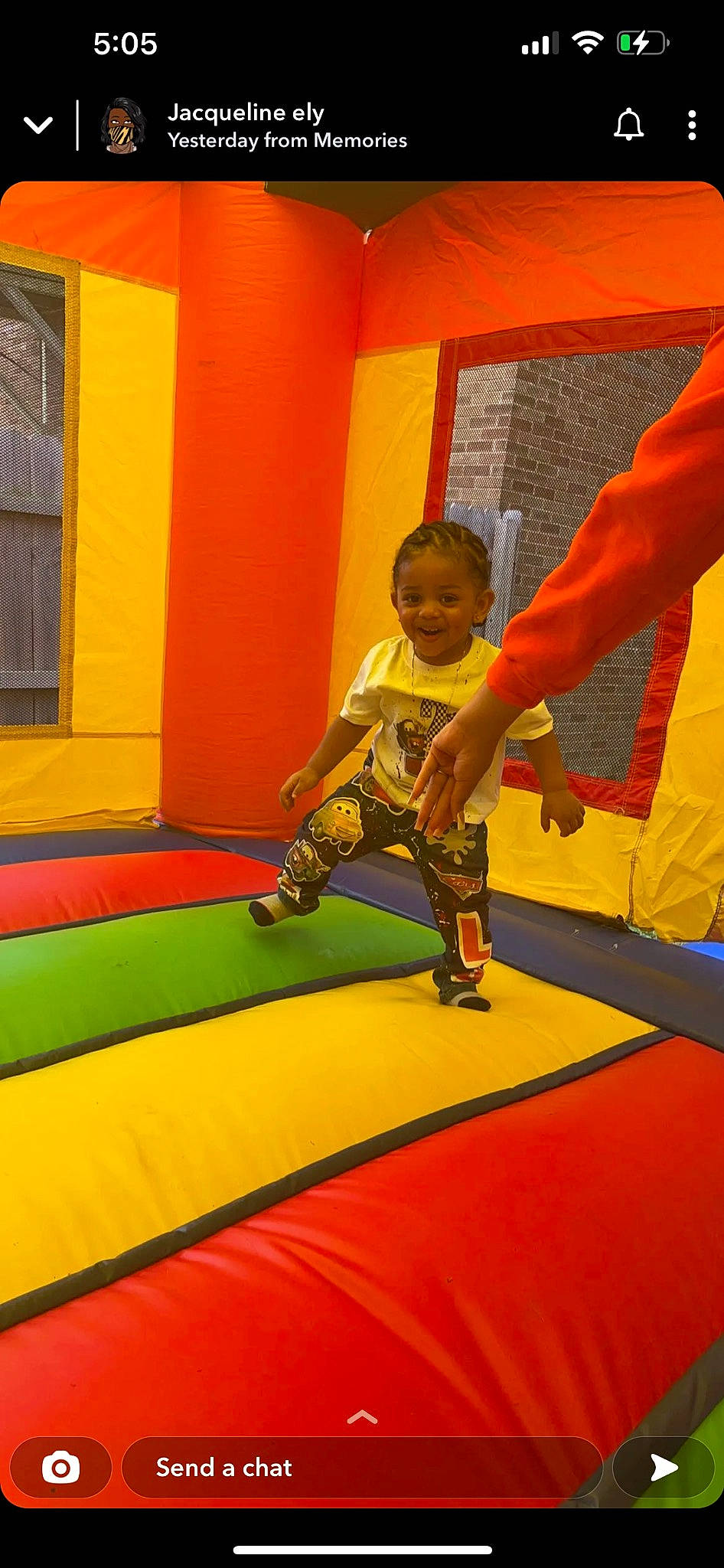 Luis is registered to the contest to win money with this photo: bounce_house, carpet, elbow, flooring, fun, games, grass, human_leg, inflatable, joy, knee, leisure, orange, outdoor_play_equipment, person, play, playground, recreation, shorts, smile