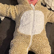 Noélan a rejoint le concours — aidez-le/la à gagner de superbes lots ! baby, child, onesie, costume, fluffy, cute, infant, face, hood, zipper, couch, blanket, soft, sleepwear, footed_pajamas, person, indoor, comfortable, warm, lying_down
