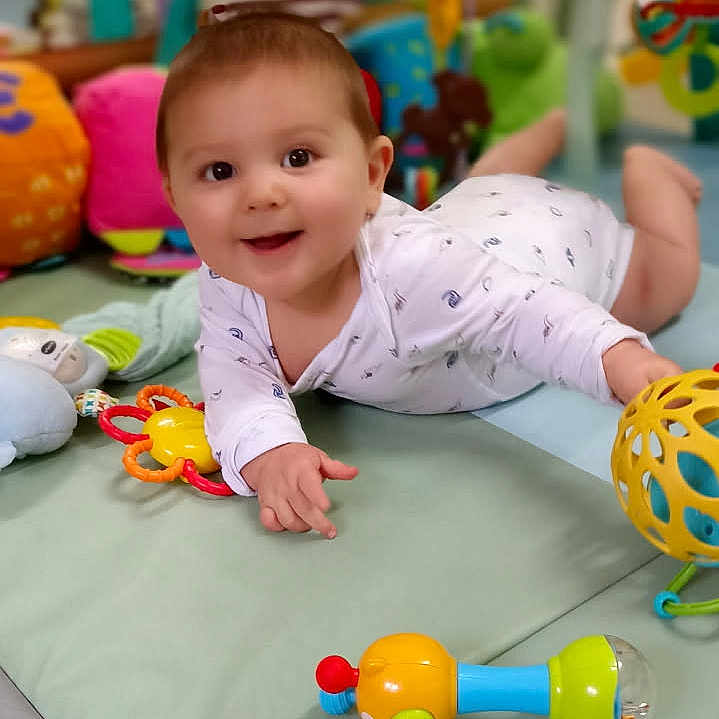 Noélan a rejoint le concours — aidez-le/la à gagner de superbes lots ! baby, child, clothing, colorful, crawling, cute, face, floor, happy, home, indoor, infant, person, play_mat, playtime, rattle, smiling, soft_toys, toys, young_child
