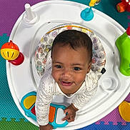 Joyce joined the competition — help win amazing prizes! baby, child, activity_center, toy, colorful, foam_tiles, smiling, indoor, playtime, cute, infant, happy, person, clothing, plastic, floor, bright, early_childhood, looking_up, play